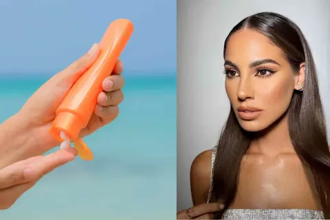 Mano con crema solare arancione, per godersi il sole in sicurezza. Si abbronza con la protezione 50, per una pelle protetta e luminosa.