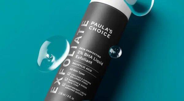 Flacone di esfoliante viso Paula's Choice 2% BHA Liquid Exfoliant, con gocce d'acqua. Scopri come si usa per una pelle levigata.