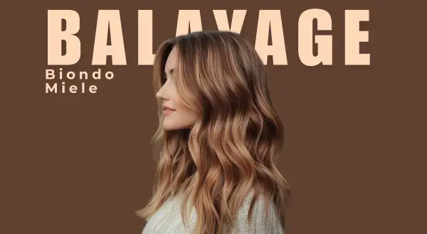 Balayage con riflessi biondo miele dorato su base castana. Capelli mossi e luminosi, un look naturale e chic.