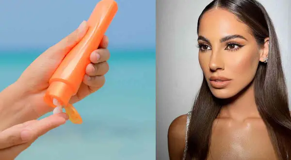 Mano con crema solare arancione, per godersi il sole in sicurezza. Si abbronza con la protezione 50, per una pelle protetta e luminosa.